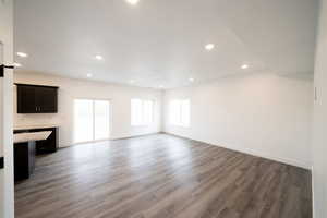 Photo of home built in past by OLO. Unfurnished living room with dark wood finished floors and recessed lighting