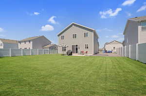 Rear view of property with a patio and a fenced backyard