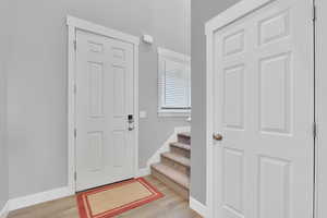 Entryway featuring light wood-style flooring and stairway
