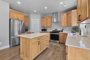 Kitchen featuring appliances with stainless steel finishes, recessed lighting, a center island, and light brown cabinets