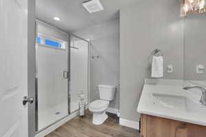 Bathroom featuring vanity, a stall shower, and light wood finished floors