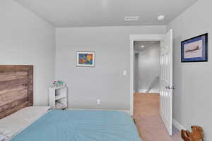 Carpeted bedroom with baseboards