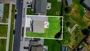 Aerial view of property and surrounding area featuring property boundaries highlighted