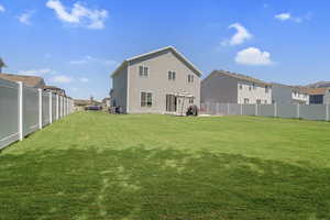 Rear view of property with a fenced backyard, a residential view, and a patio area