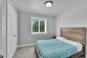 Bedroom with carpet floors and a textured ceiling
