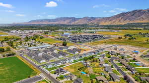 View of property location with a mountain backdrop and nearby suburban area