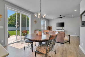 Dining space featuring a chandelier, light wood-style floors, recessed lighting, and a ceiling fan