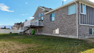 Rear view of property with stairway and a deck