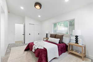 Bedroom with vaulted ceiling, light colored carpet, a closet, and recessed lighting