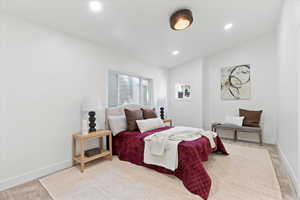 Carpeted bedroom featuring vaulted ceiling and recessed lighting