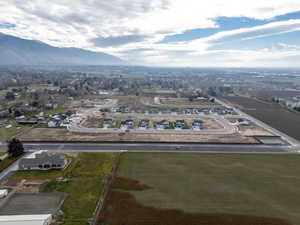 Aerial view of property and surrounding area featuring a mountain backdrop