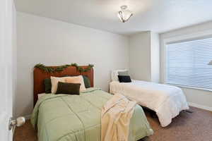 Carpeted bedroom with baseboards