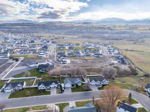 Aerial overview of property's location with nearby suburban area and a mountain backdrop
