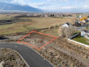 Overview of rural landscape featuring property parcel outlined and a mountainous background