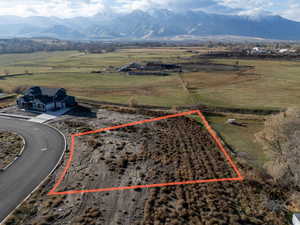 Overview of rural landscape featuring property boundaries highlighted and a mountainous background