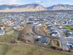 Aerial overview of property's location featuring nearby suburban area and a mountain backdrop