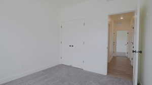 Unfurnished room featuring carpet flooring and baseboards