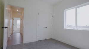 Unfurnished bedroom with carpet flooring and a closet