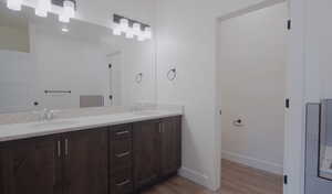 Bathroom featuring double vanity and light wood-type flooring