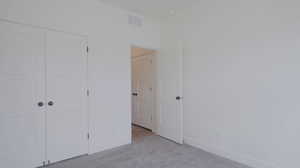 Unfurnished bedroom featuring a closet and carpet floors