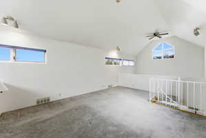 Bonus room with a ceiling fan and vaulted ceiling