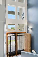 Entryway featuring a high ceiling and abundant windows