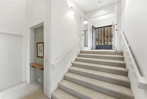 Staircase leading to primary suite and loft