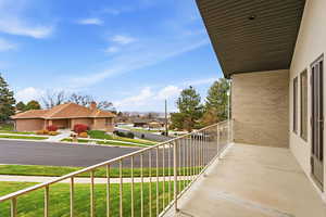 Balcony featuring a residential view and lake view