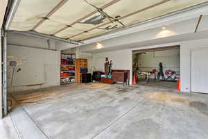 View of 3 car garage and heated workshop