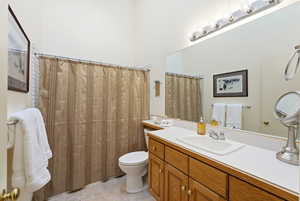 Full bathroom featuring vanity, a shower with curtain, and light tile patterned floors