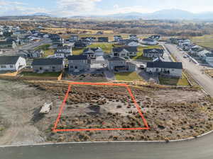 Aerial view of residential area featuring property parcel outlined and a mountainous background