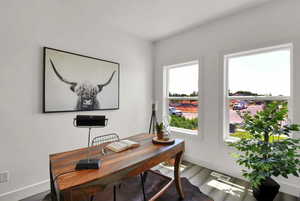 Office space featuring baseboards and wood finished floors