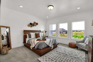 Carpeted bedroom with baseboards and recessed lighting