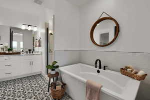 Bathroom featuring vanity, a shower stall, and a soaking tub