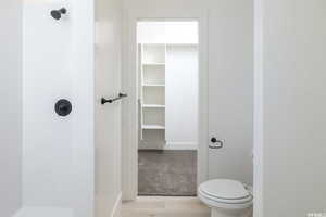 Bathroom with a spacious closet and a shower