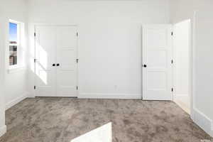 Unfurnished bedroom with a closet and carpet