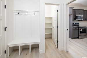 Mudroom with light wood-style floors