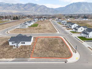 Aerial perspective of suburban area featuring property parcel outlined and mountains