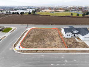 Aerial view of property and surrounding area featuring property parcel outlined