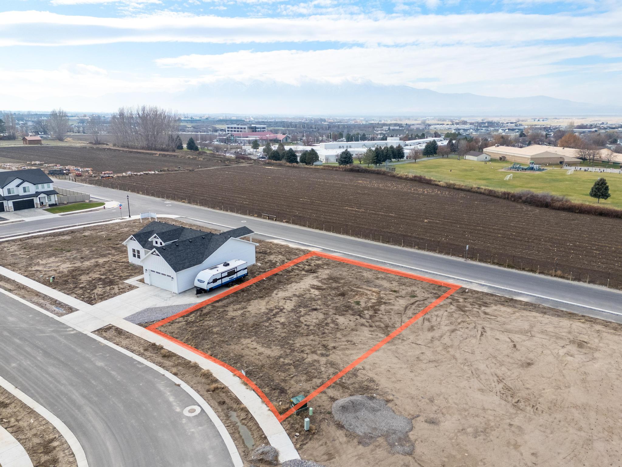 Aerial view of property and surrounding area featuring property parcel outlined