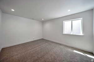 Empty room featuring carpet flooring and recessed lighting