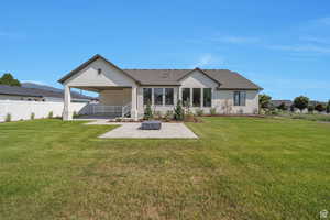 Back of property featuring a patio area and roof with shingles