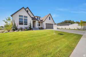 Modern inspired farmhouse with driveway and a garage