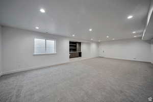 Basement featuring recessed lighting and light carpet