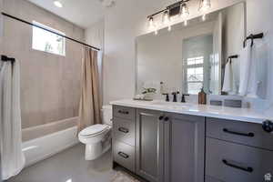 Full bath featuring shower / bath combination with curtain, light tile patterned flooring, and vanity