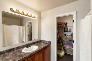 Bathroom with curtained shower and vanity