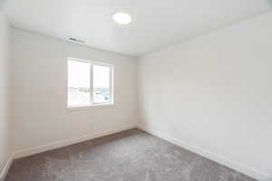 Empty room with baseboards and carpet