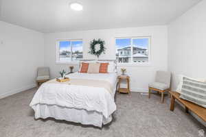 Bedroom featuring light carpet