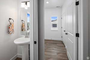 Bathroom featuring light wood-type flooring and baseboards