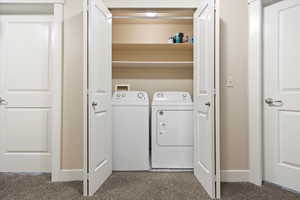 Laundry area featuring independent washer and dryer and baseboards